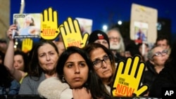 FILE— Israeli demonstrators call on the government to secure the release of hostages held in the Gaza Strip by Hamas during a rally outside the Knesset, Israel's parliament, in Jerusalem, Sunday, April 7, 2024.