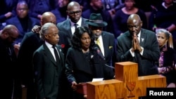 Flanked by the Rev. Al Sharpton and her husband, Rodney Wells, RowVaughn Wells speaks during the funeral service for her son Tyre Nichols at Mississippi Boulevard Christian Church in Memphis, Tenn., Feb. 1, 2023. 