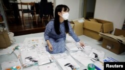 Youth activist and a member of "No Youth No Japan", Ayumi Adachi (20), conducts shipping work of T-shirts for a campaign to urge young people to vote during elections, at her house in Tokyo, Japan, Oct. 20, 2021.