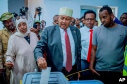 Presidential candidate Abdirahman Mohamed Abdullahi, center, casts his vote inside a polling station during the presidential election in Hargeisa, Somaliland, Nov. 13, 2024.