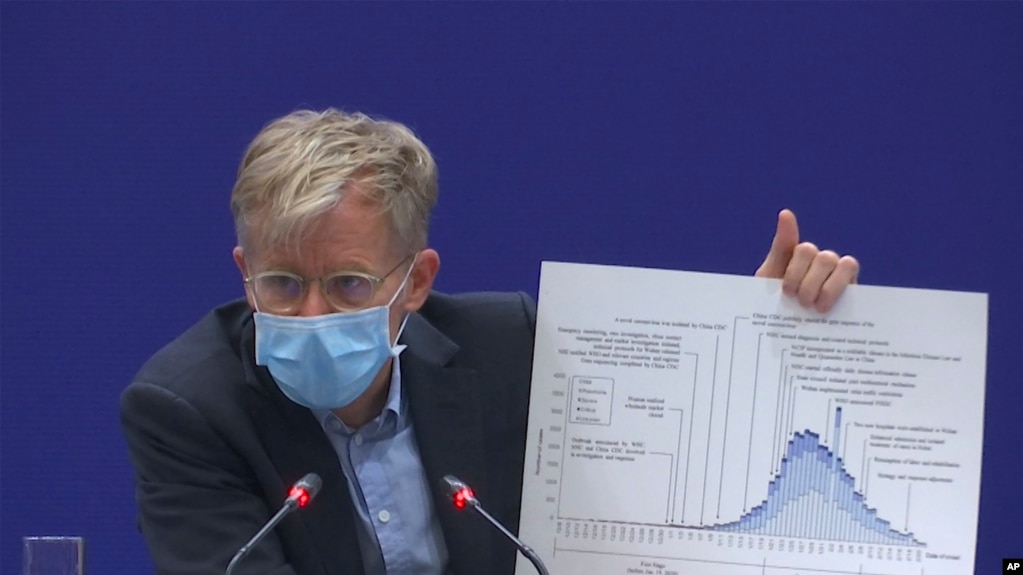 Bruce Aylward, an assistant director-general of the World Health Organization speaks with a chart during a press conference in Beijing on Monday, Feb. 24, 2020. 