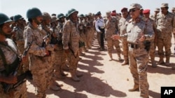 Yemeni Defense Minister Mohammad Nasser Ahmad, right, inspects troops at a military site in the southern province of Shabwa, April 28, 2014.