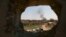 FILE - Smoke rises over Islamic State-held Baghouz, the last territory held by militants in Syria, as U.S.-backed Syrian Democratic Forces pound area with airstrikes, artillery on March 11, 2019.