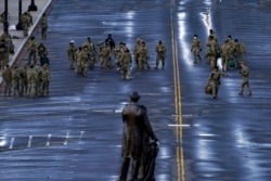 National Guard members walk in a security zone ahead during Joe Biden's presidential inauguration at the U.S. Capitol in Washington, Jan. 20, 2021.