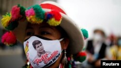 A supporter wearing a face mask with the image of Peru's presidential candidate Pedro Castillo marches in Lima, Peru, June 26, 2021.
