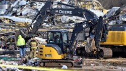 Emergency response workers dig through the rubble of the Mayfield Consumer Products candle factory in Mayfield, Kentucky, Dec. 11, 2021, after it was destroyed by a tornado.