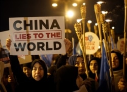 FILE - Protesters march in support of China's Uighurs in Istanbul, Turkey, Dec. 20, 2019.