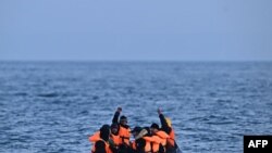 FILE—Migrants travel in an inflatable boat across the English Channel, bound for Dover on the south coast of England.