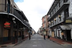 FILE - A view of empty Bourbon Street in the French Quarter amid the coronavirus pandemic on March 27, 2020, in New Orleans.