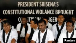 Members of a civil society group attend a silent protest to demand democracy, after Sri Lankan opposition leader Mahinda Rajapaksa was appointed prime minister when President Maithripala Sirisena dismissed Ranil Wickremesinghe, in Colombo, Sri Lanka, Nov. 21, 2018.