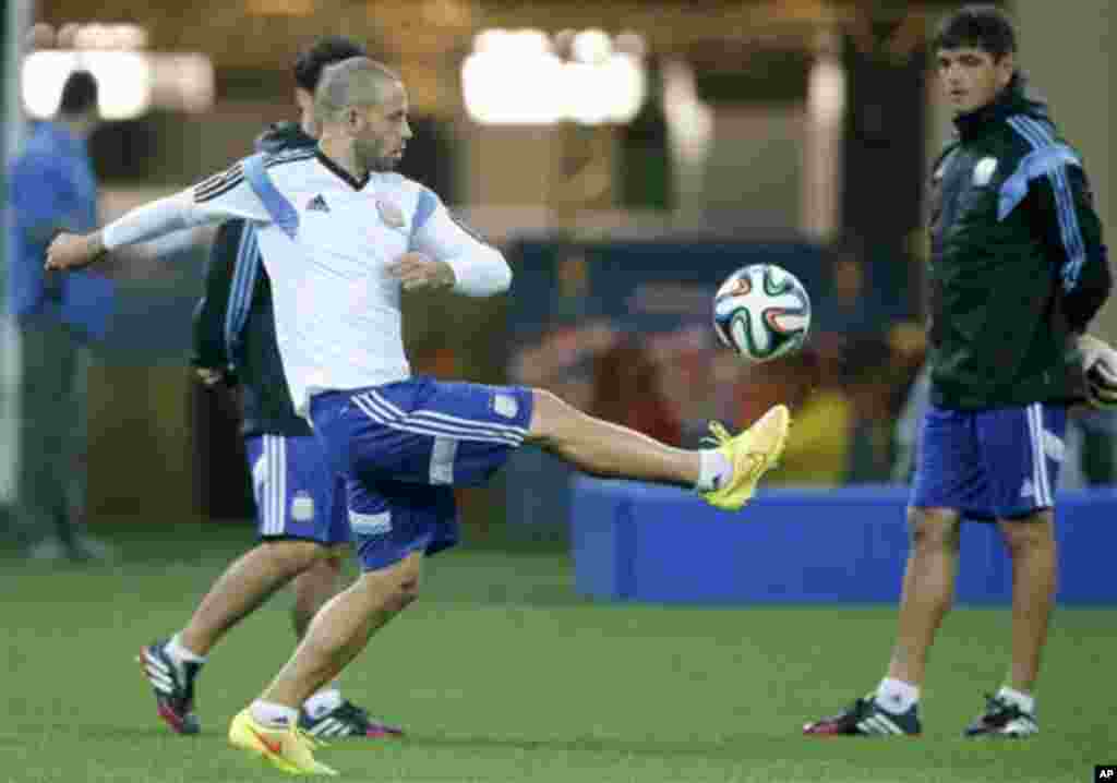 Argentina's Javier Mascherano kicks the ball during a training session one day before their World Cup semifinal soccer match between Netherlands and Argentina at Itaquerao Stadium in Sao Paulo, Brazil, Tuesday, July 8, 2014. (AP Photo/Victor R. Caivano)