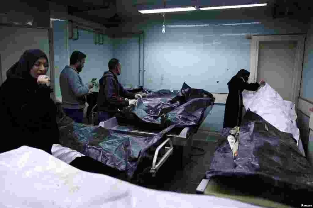 People look at bodies, believed to be of prisoners from Sednaya prison, according to forensic official Zaher al-Taqesh, at the Al Mojtahed hospital in Damascus, Syria, Dec. 10, 2024.