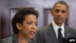 FILE - President Barack Obama, right, looks on as his nominee for U.S. Attorney General, Loretta Lynch, speaks during an event at the White House in Washington, D.C., November 8, 2014. 