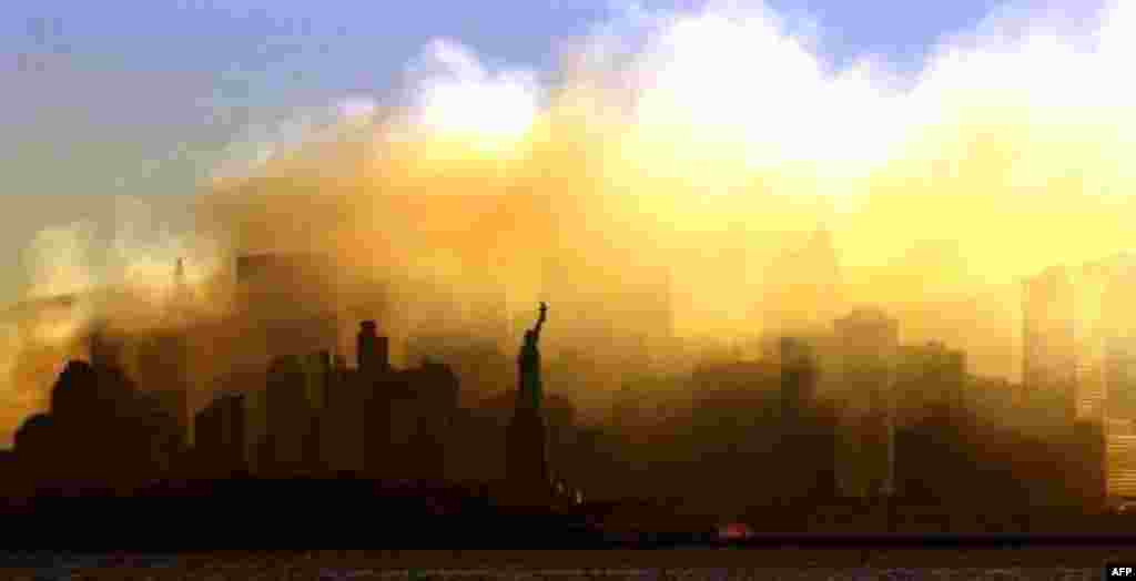 The Statue of Liberty can be seen at first light from a view from Jersey City, N.J., as the lower Manhattan skyline is seen though a thick smoke filled the sky early Saturday, Sept. 15, 2001. New York continues to recover following terrorist attacks at t