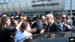 Egyptian Prime Minister Sherif Ismail talks to reporters at Cairo International Airport, May 19, 2016.