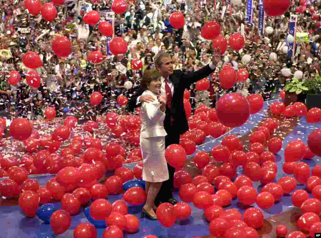 FILE - Republican presidential nominee George W. Bush and his wife, Laura, are engulfed in balloons at the close of the Republican National Convention in Philadelphia, Aug. 3, 2000. Bush and Dick Cheney received the presidential and vice presidential nominations, respectively.