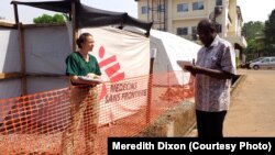 CDC epidemiologist Meredith Dixon confers with another physician at the Doctors Without Borders Ebola treatment center at Donka hospital in Conakry, Guinea, Dec. 19, 2014.