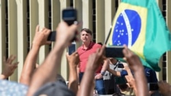 President Jair Bolsonaro speaks in a protest in Brasilia against quarantine and social distancing measures to fight the coronavirus outbreak, on April 19, 2020.