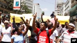 Kenya civil rights groups protest on the streets of Nairobi holding placards against the government closure of the three main TV stations in Nairobi, Feb. 5, 2018. 