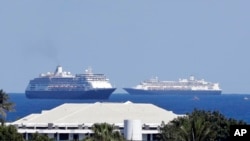 The cruise ships Zaandam, foreground, and Rotterdam make their way to Port Everglades, April 2, 2020, in Fort Lauderdale, Fla. 