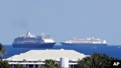 The cruise ships Zaandam, foreground, and Rotterdam make their way to Port Everglades, April 2, 2020, in Fort Lauderdale, Fla. 