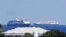 The cruise ships Zaandam, foreground, and Rotterdam make their way to Port Everglades, April 2, 2020, in Fort Lauderdale, Fla. 