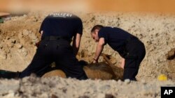 Experts prepare a WWII bomb for removal in Berlin, April 20, 2018. 
