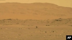 FILE - In this image from NASA, NASA's experimental Mars helicopter Ingenuity lands on the surface of Mars Monday, April 19, 2021. 