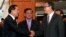 Cambodian Prime Minister Hun Sen, left, shakes hands with opposition party leader Sam Rainsy, right, after a meeting, as Sar Kheng, center, deputy prime minister, looks on at the National Assembly in Phnom Penh, Cambodia, Monday, Sept. 16, 2013. 