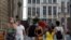 People wear protective face masks as they walk through the Grand Place in the historical center of Brussels, Belgium, Aug. 12, 2020.