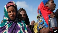 FILE: Women and children queue to receive food at a World Food Program distribution center in Mogadishu. Drought, conflict and a lack of food aid have left millions of people at risk of starvation in southern Somalia. Taken 4.5.2012