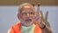 Gujarat state chief minister and the prime ministerial candidate of India's main opposition Bharatiya Janata Party (BJP), Narendra Modi, flashes a victory sign to the media during a meeting of the BJP members of Gujarat’s state legislature in Gandhinagar.