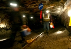 FILE - Ohio coal miners head into the mine for a shift inside the Hopedale Mine near Cadiz, Ohio, March 10, 2006.