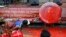 Indigenous people, including Muslims from the besiege city of Marawi, throw red paint at the mock seal of President Rodrigo Duterte to protest the continued siege and the martial law imposed by Duterte on the Mindanao region, Aug. 31, 2017, in Manila, Philippines.