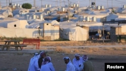 Displaced Iraqi men from the minority Yazidi sect, who fled the Iraqi town of Sinjar, are seen at the Khanki camp on the outskirts of Dohuk province, July 31, 2019. 