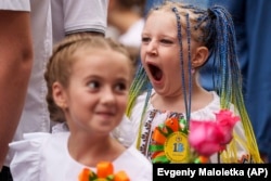 Children attend the traditional ceremony for the first day of school in Zaporizhzhia, Ukraine, Sunday Sept. 1, 2024. (AP Photo/Evgeniy Maloletka)