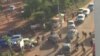 In this image made available by Malikahere.com security personnel, right, arrive close to the scene of an attack on a hotel in Bamako, Mali, Nov. 20, 2015. 