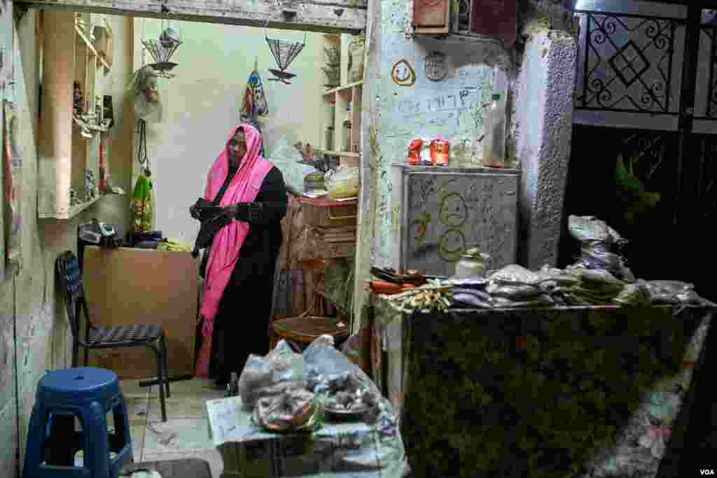 Manal Ahmed, who came from Omdurman because of the lack of the medical care in Sudan, says &quot;I came here to get my son treatment in better hospitals, then I started this shop to sell herbs to help my family with living expenses.&quot; In Cairo. (H. Elrasam/VOA)