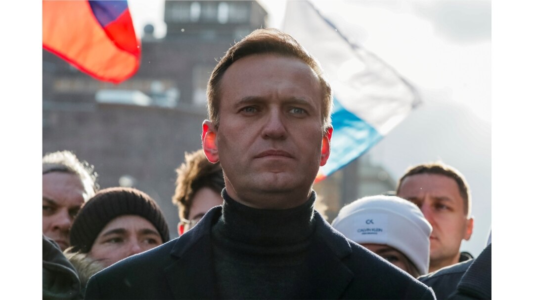 FILE - Russian opposition politician Alexei Navalny takes part in a rally to mark the 5th anniversary of opposition politician Boris Nemtsov's murder and to protest against proposed amendments to the country's constitution, in Moscow, Feb. 29, 2020.