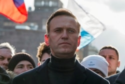 FILE - Russian opposition politician Alexei Navalny takes part in a rally, in Moscow, Feb. 29, 2020.