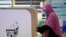 Seorang perempuan memberikan suaranya saat pemilihan negara bagian di sebuah pusat pemungutan suara di Malaka, Malaysia, Sabtu, 20 November 2021. (Foto: AP)