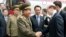 Choe Ryong-Hae, left, director of the General Political Bureau of the Korean People's Army (KPA) of North Korea, shakes hands with Chinese official upon arrival at the airport, Beijing, May 22, 2013.