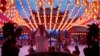 A Malaysian ethnic Chinese man offer prayers under the illuminated traditional Chinese lanterns on the eve of Lunar New Year in Kuala Lumpur, Malaysia, Sunday, Feb. 7, 2016. 