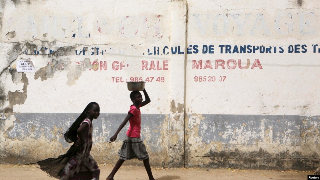 FILE - Girls walk on a road in Maroua, Cameroon, March 17, 2016. Amid misconceptions and skepticism surrounding HPV vaccinations in the country, efforts are underway to educate parents about the importance of having girls vaccinated.