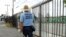 FILE - An inspector with the Miami-Dade County mosquito control department, looks for standing water as he inspects an empty lot, Aug. 2, 2016, in the Wynwood neighborhood of Miami, Florida.