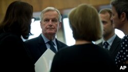 EU chief Brexit negotiator Michel Barnier, second left, talks to other European Commissioners before a weekly meeting at the European Commission headquarters in Brussels, Wednesday, Oct. 10, 2018. 