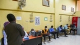 People wait to receive a dose of the Oxford-AstraZeneca COVID-19 coronavirus vaccine at the Jabra Hospital for Emergency and Injuries in Sudan's capital Khartoum on March 9, 2021. 