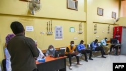 People wait to receive a dose of the Oxford-AstraZeneca COVID-19 coronavirus vaccine at the Jabra Hospital for Emergency and Injuries in Sudan's capital Khartoum on March 9, 2021. 