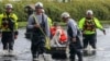 Amy Bishop is evacuated from her home by Pasco County Fire and Rescue and Sheriff's Office teams as waters rise in her neighborhood after Hurricane Milton caused the Anclote River to flood, Oct. 11, 2024, in New Port Richey, Fla. 