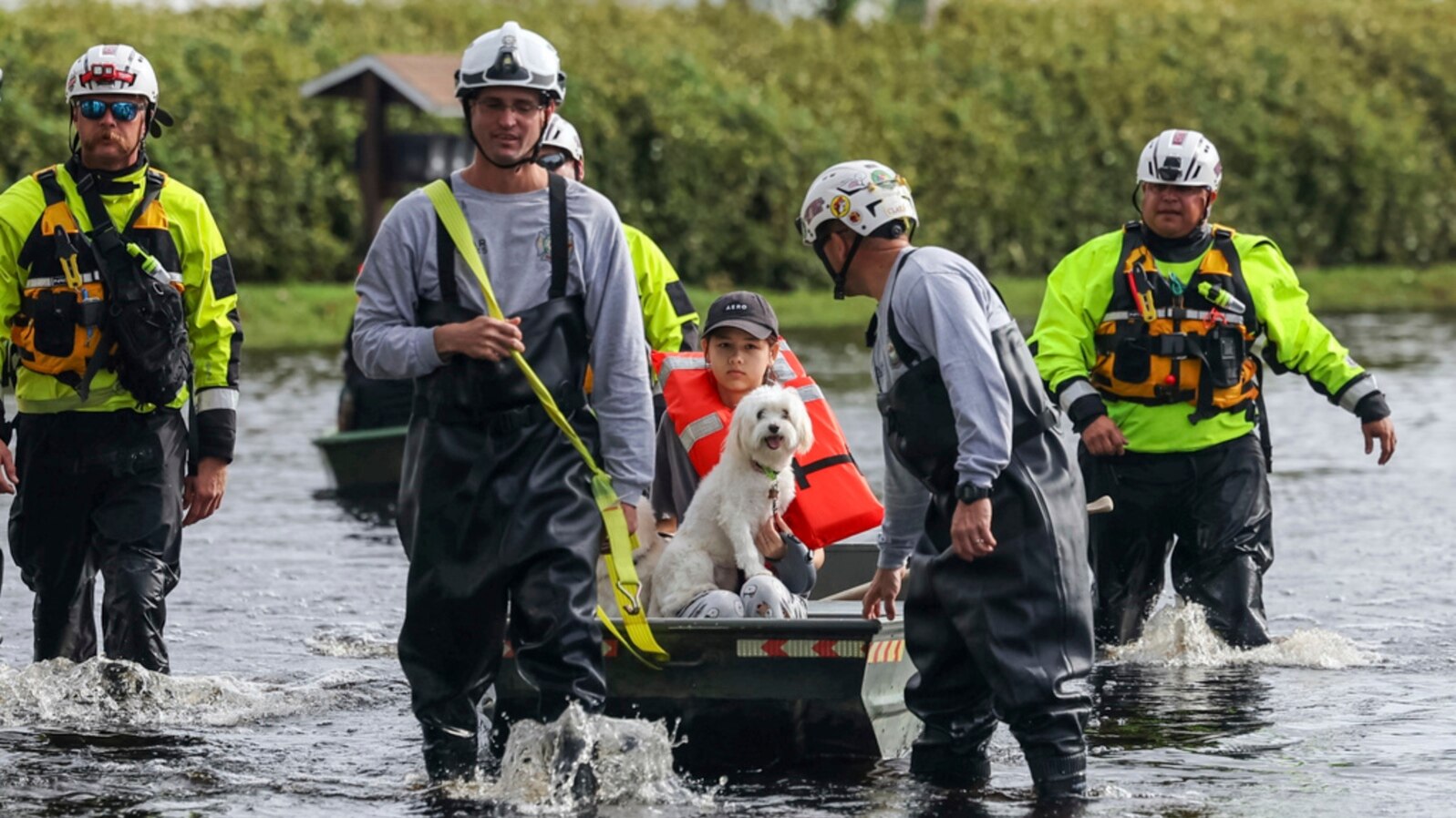 Amy Bishop is evacuated from her home by Pasco County Fire and Rescue and Sheriff's Office teams as waters rise in her neighborhood after Hurricane Milton caused the Anclote River to flood, Oct. 11, 2024, in New Port Richey, Fla. 